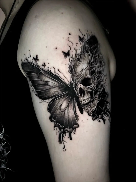 Black and Grey Skull Butterfly on Women Upper Arm Tattoo by @inksane_needles