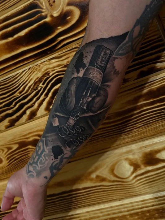 Big Black and Grey Skull and Bottle Tattoo on Men Inner Arm by @paco_tat2