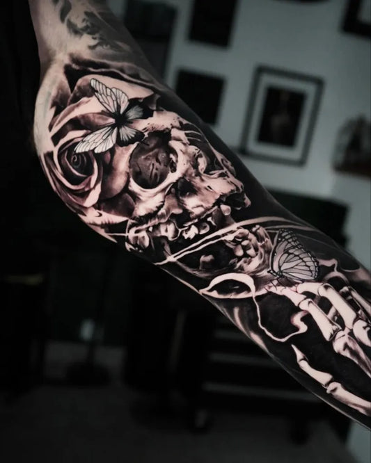 Big Black and Grey Skull and Rose Tattoo on Men Inner Arm by @tattoo_mart