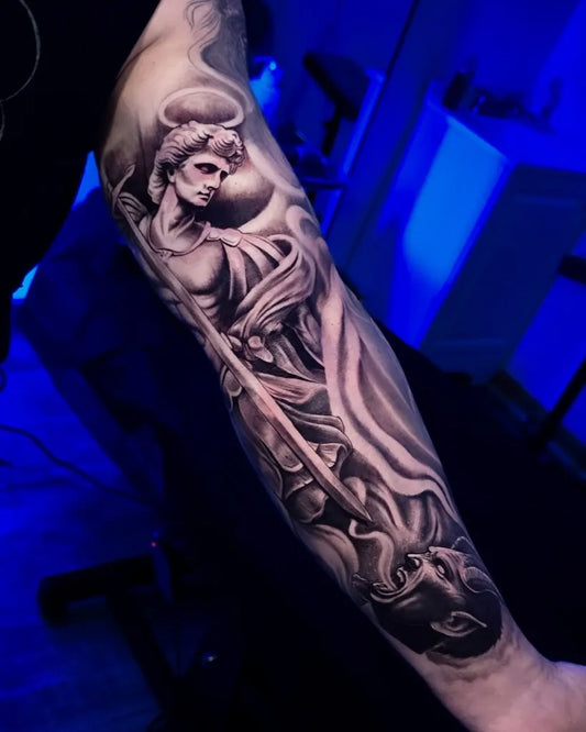 Big Black and Grey St Michael Slaying Dragon Tattoo on Men Arm by @angeloctopus.studio