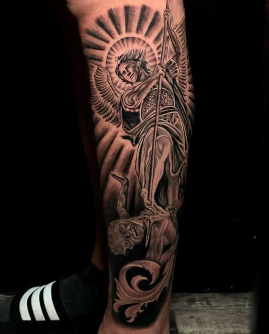 Big Black and Grey St Michael Slaying Dragon Tattoo on Men Leg by @embassytattoo