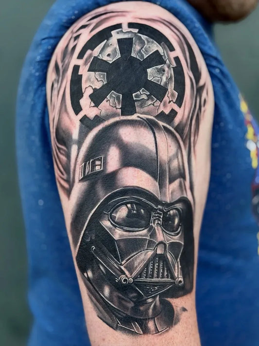 Big Black and Grey Star Wars Darth Vader Imperial Emblem Tattoo on Men Shoulder by @scarsandstoriestattoo