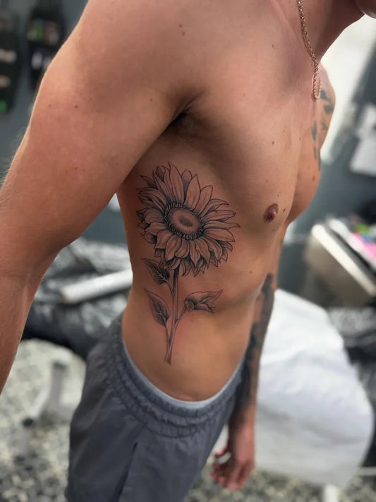 Big Black and Grey Sunflower on Men Rib Tattoo by @monkeybach