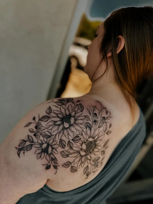 Big Black and Grey Sunflowers and Leaves on Women Shoulder Tattoo by @sondertattooco