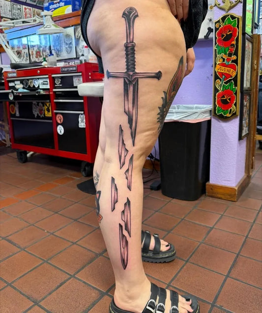 Big Black and Grey Sword on Women Thigh Tattoo by @avenuetattoos
