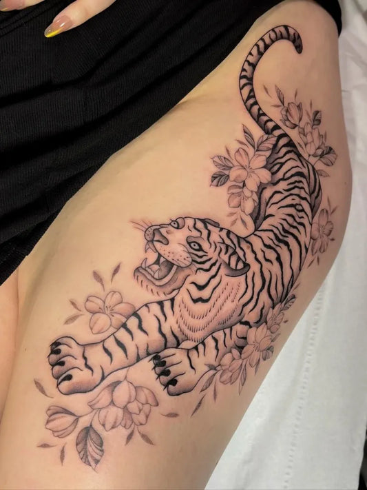 Big Black and Grey Tiger with Flowers on Women Thigh Tattoo by @lucie.tattoo