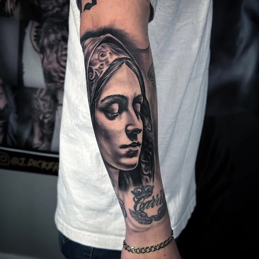 Big Black and Grey Virgin Mary with Name Tattoo on Men Arm by @jdickersontattoos