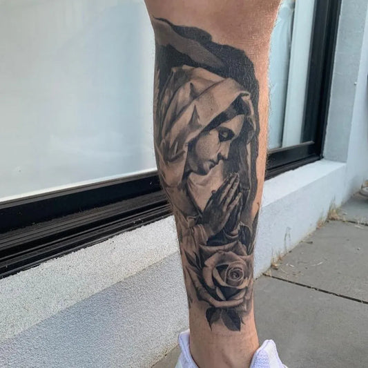 Big Black and Grey Virgin Mary with Rose Tattoo on Men Calf by @colemorelandart