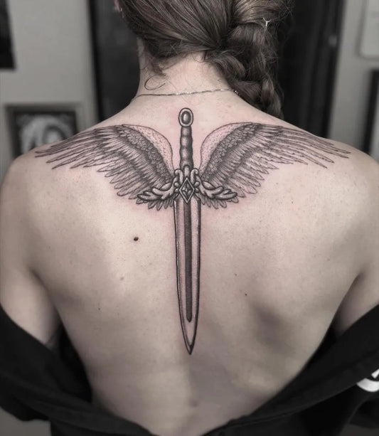 Big Black and Grey Winged Sword on Women Back Tattoo by @marlotattoos