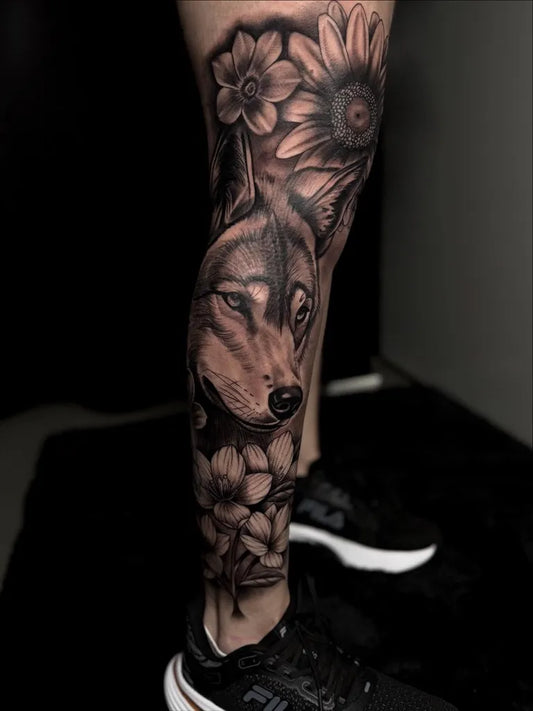 Big Black and Grey Wolf and Flowers on Women Leg Tattoo by @mikaelvitali_tattoo