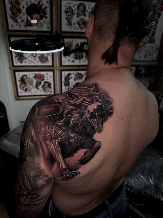 Big Black and Grey Wolf on Men Shoulder Tattoo by @jasonjohnmiles.tattoo