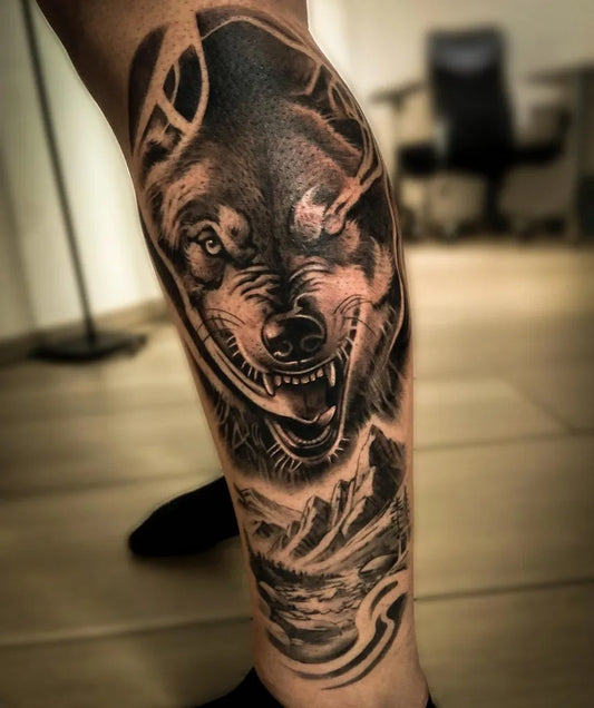 Big Black and Grey Wolf with Mountains on Men Leg Tattoo by @lucatattooart