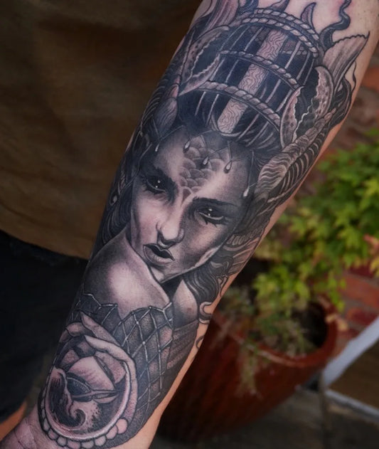 Big Black and Grey Woman with Crown and Bird Cage Nautical Tattoo on Women Arm by @dancocktattoo