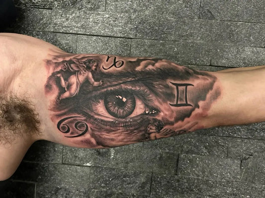 Big Black and Grey Zodiac Eye Tattoo on Men Bicep by @halloweenink