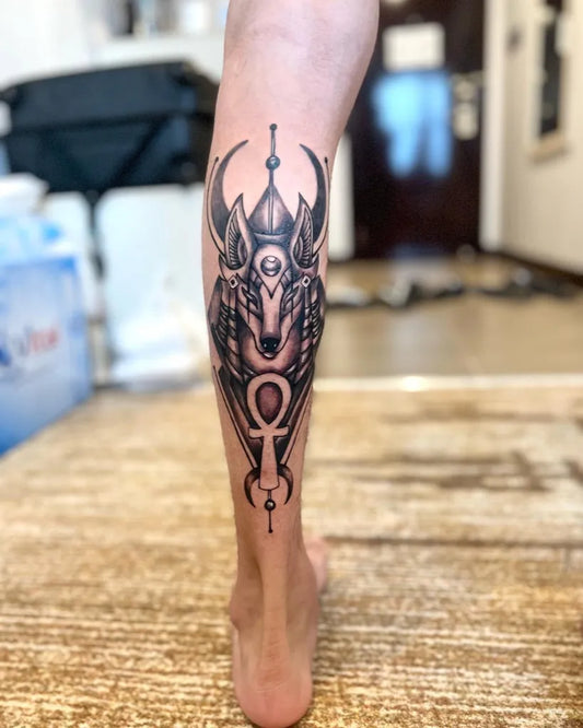 Big Blackwork Anubis Head with Ankh Tattoo on Women Leg by @viperink_tattoostudio