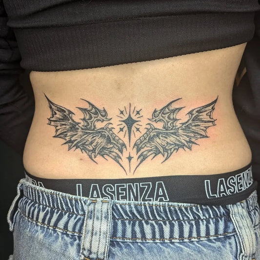 Big Blackwork Bat Wings with Star Tattoo on Women Lower Back by @erynalexanderr
