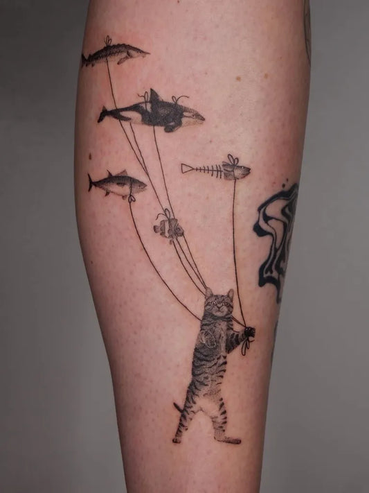 Big Blackwork Cat Fishing Dolphins Tattoo on Men Arm by @surrealismtattoo