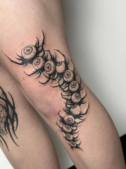 Big Blackwork Centipede Eye Tattoo on Women Thigh by @harrisonb_tattoos