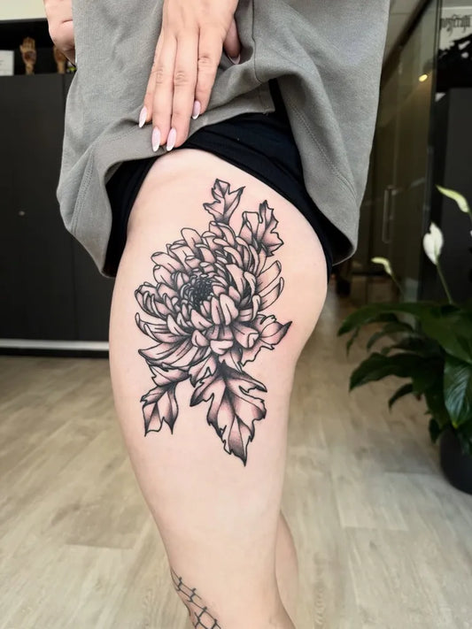 Big Blackwork Chrysanthemum Tattoo on Women Thigh by @morgan.lefay.tattoo