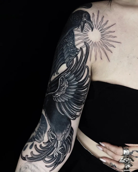 Big Blackwork Crow and Sun Tattoo on Women Arm by @needle.mistress