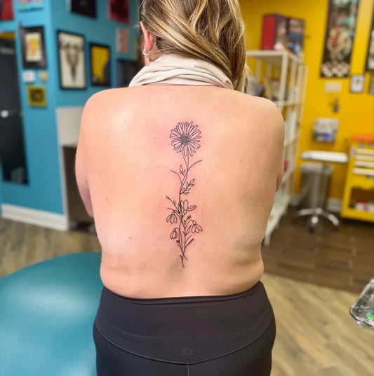 Big Blackwork Daisy on Women Spine Tattoo by @kelseyalysee