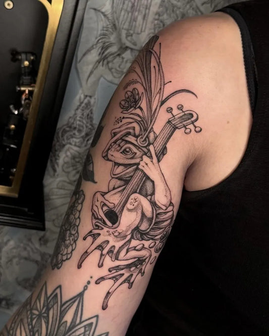 Big Blackwork Frog Musician Tattoo on Women Arm by @skullcult