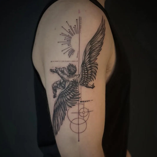 Big Blackwork Icarus with Wings and Sun on Men Arm Tattoo by @shan_zooztattoo
