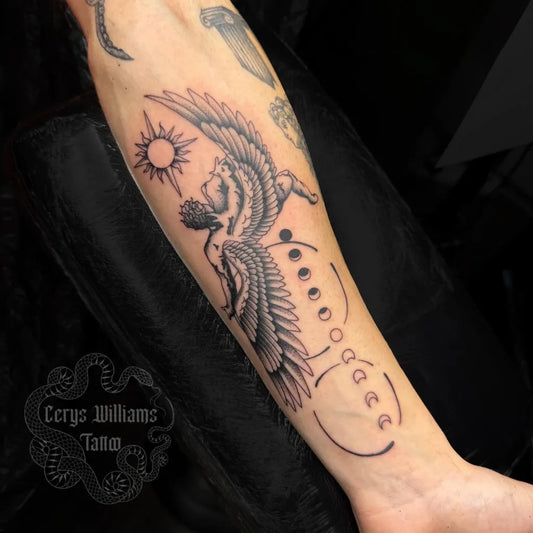 Big Blackwork Icarus with Wings and Sun on Men Arm Tattoo by @wishbonetattoostudio