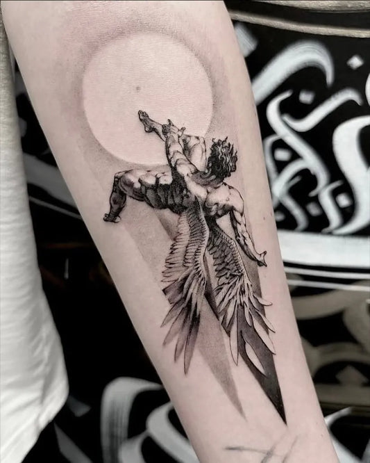 Big Blackwork Icarus with wings on Men Arm Tattoo by @dodaj_ink