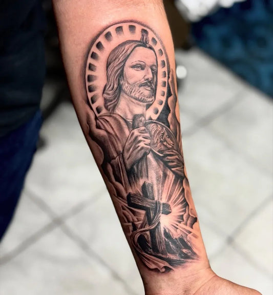Big Blackwork Jesus with Cross on Men Arm Religious Tattoo by @lovettetattoos