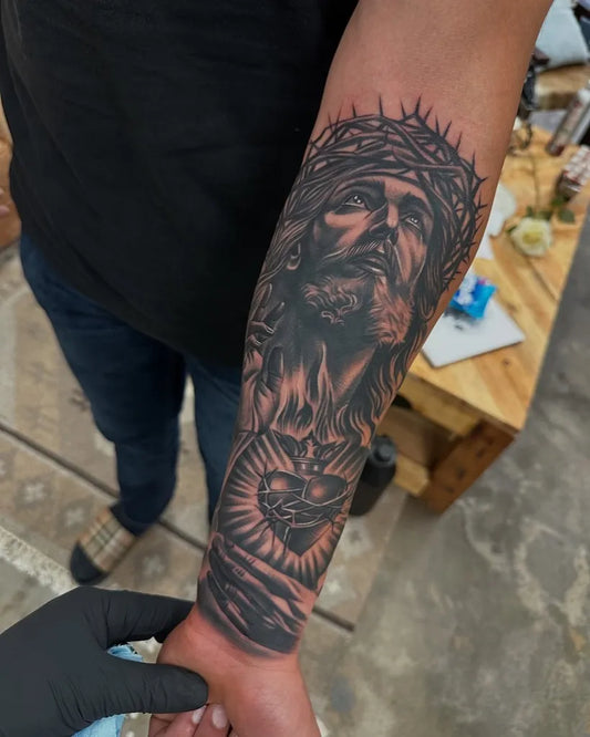 Big Blackwork Jesus with Crown of Thorns and Sacred Heart on Men Arm Religious Tattoo by @thedansal