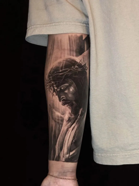 Big Blackwork Jesus with Crown of Thorns on Men Arm Religious Tattoo by @kibavu_tattoo