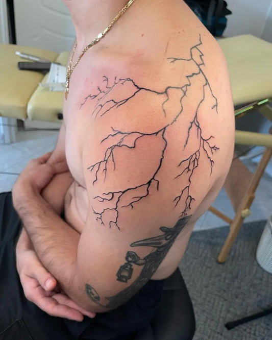 Big Blackwork Lightning Tattoo on Men Shoulder by @inkspiration.cologne