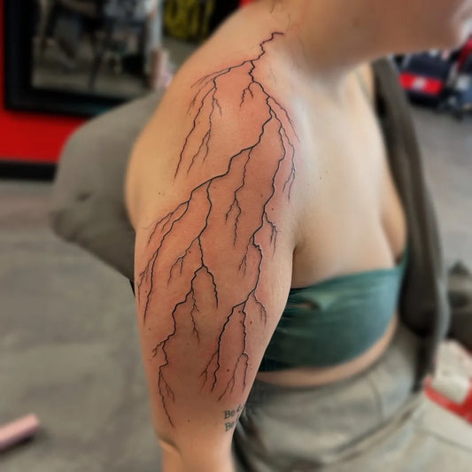 Big Blackwork Lightning Tattoo on Women Shoulder by @lauryn.ink