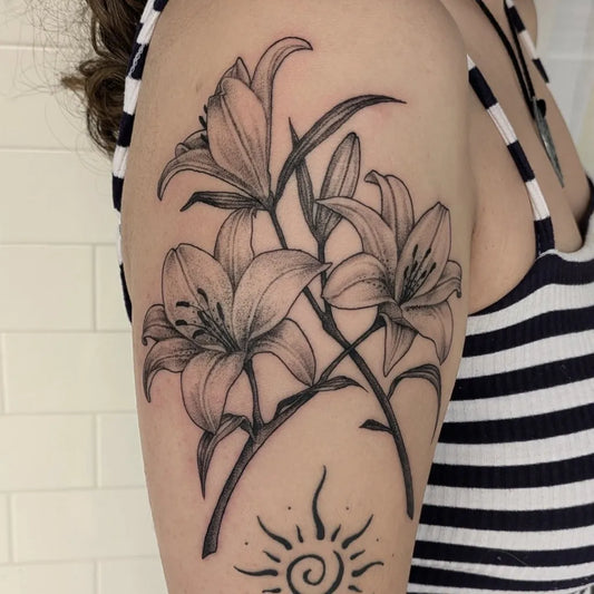 Big Blackwork Lilies and Sun on Women Arm Flower Tattoo by @rhylandmaytatts