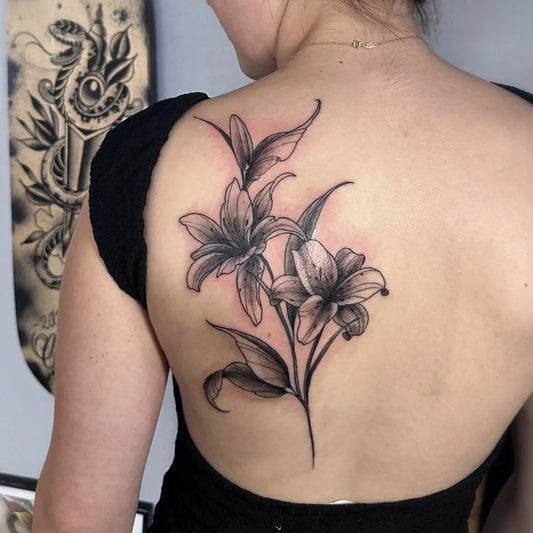 Big Blackwork Lily Flowers on Women Shoulder Flower Tattoo by @orphicartcollective_tattoo
