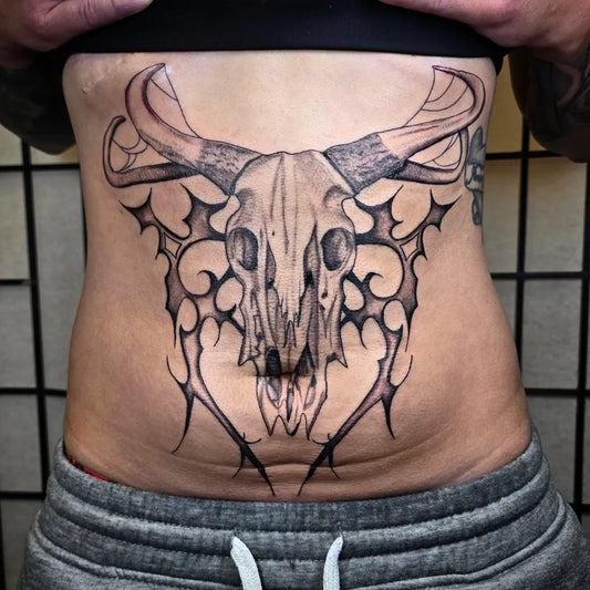 Big Blackwork Longhorn Skull with Tribal Wings Tattoo on Women Stomach by @tattoos_by_linda