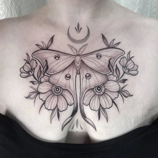 Big Blackwork Luna Moth and Flowers on Women Chest Tattoo by @alteredegotattoos