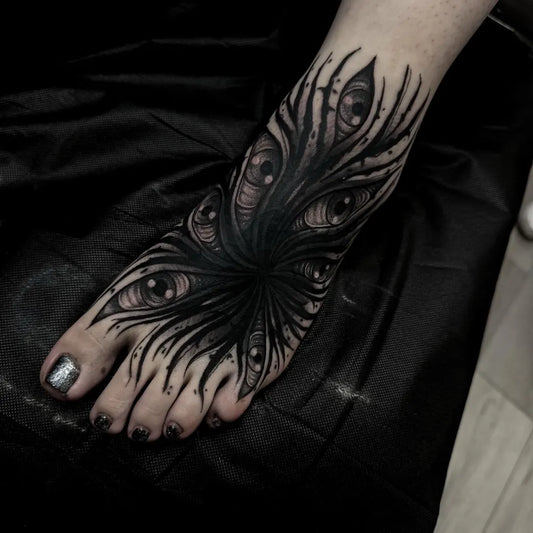 Big Blackwork Multiple Eyes Tattoo on Women Foot by @bonnie_tatt2oos