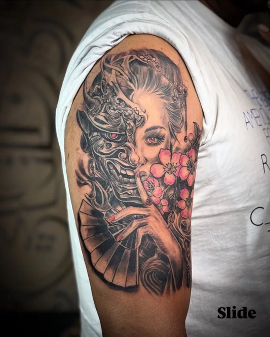 Big Blackwork Oni Mask with Cherry Blossoms and Fan on Women Shoulder Tattoo by @ink.stain.tattoos