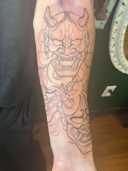 Big Blackwork Oni Mask with Flames on Men Arm Tattoo by @miiaa.tattoos