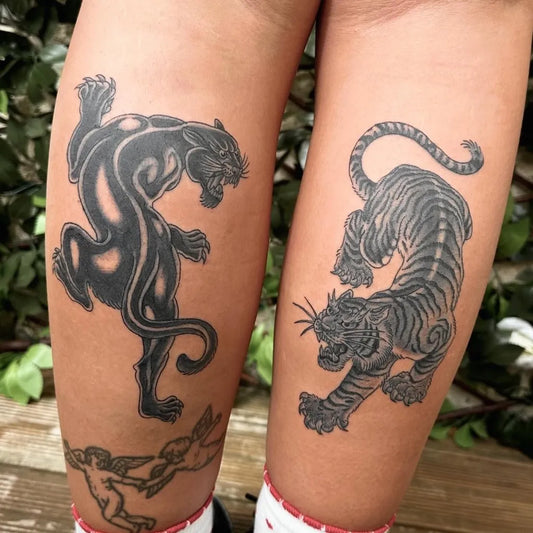 Big Blackwork Panther and Tiger Tattoo on Women Leg by @evanbyrnetattoo