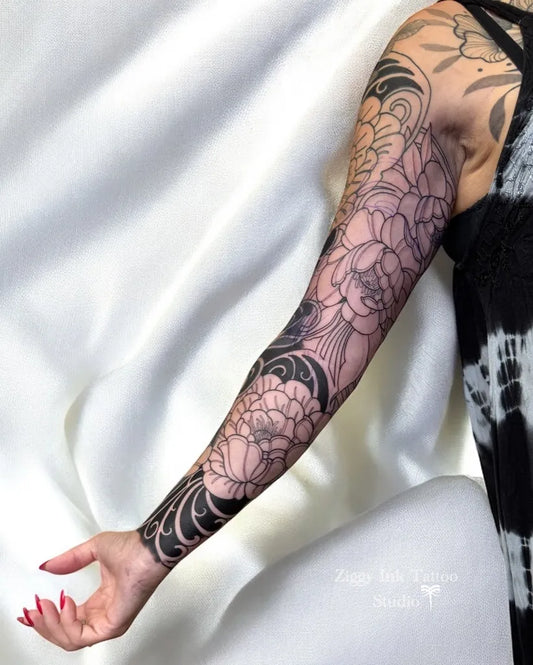 Big Blackwork Peony and Waves Tattoo on Women Upper Arm by @ziggyinktattoo