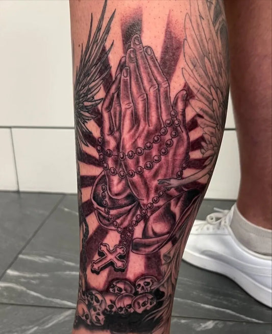 Big Blackwork Praying Hands with Rosary and Wings Tattoo on Men Leg by @charlietattooos