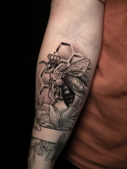 Big Blackwork Queen Bee Honeycomb Lily on Women Forearm Tattoo by @angeloctopus.studio