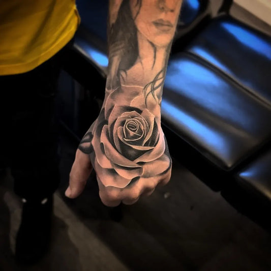 Big Blackwork Rose on Men Hand Tattoo by @aroncowlestattoo