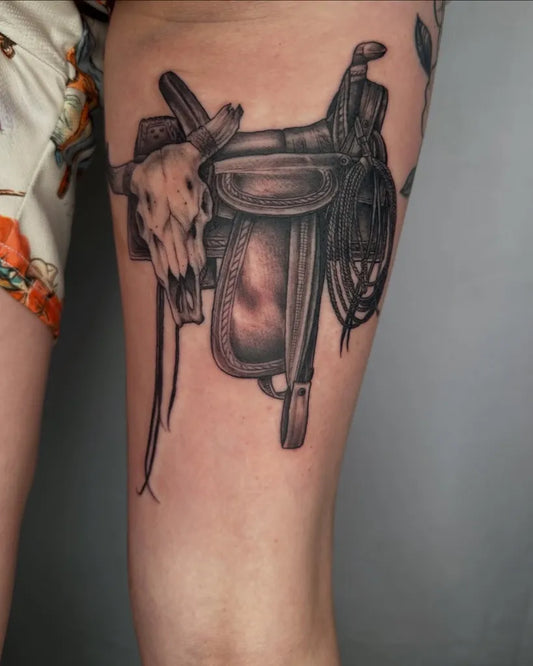 Big Blackwork Saddle Skull and Lariat on Women Thigh Tattoo by @brent_megens