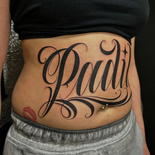 Big Blackwork Script Name Tattoo on Women Stomach by @wiskydrips