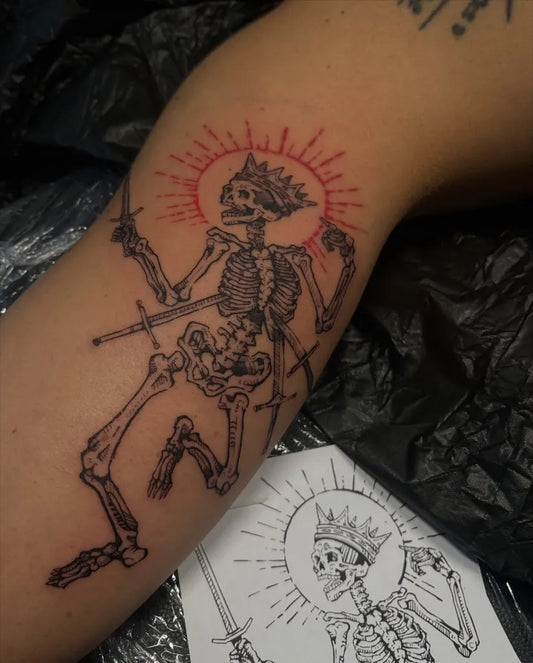 Big Blackwork Skeleton with Crown and Sword Tattoo on Women Arm by @unwanted.dahlia_ink