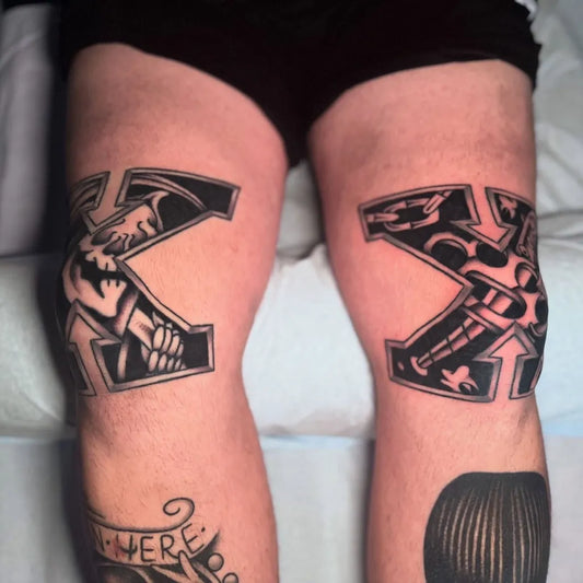 Big Blackwork Skull Cross Tattoo on Men Knee by @lindenstreettattooco